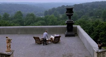 Movie still from “Hannibal” (2001), directed by Ridley Scott – A man sitting at a table on top of a roof; Extreme Wide shot, High angle