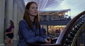 Movie still from “Hannibal” (2001), directed by Ridley Scott – A woman sitting on a chair in a room; Close Up shot, Low angle