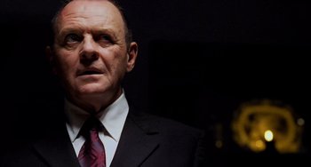 Movie still from “Hannibal” (2001), directed by Ridley Scott – An older man wearing a suit and tie; Close Up shot, Low angle