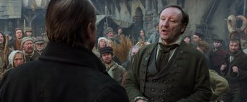 Movie still from “Hansel & Gretel: Witch Hunters” (2013), directed by Tommy Wirkola – A group of people standing around a crowd of people; Medium shot, Over the shoulder angle