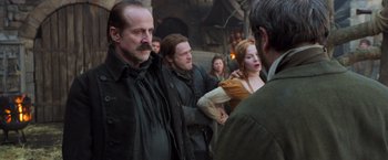Movie still from “Hansel & Gretel: Witch Hunters” (2013), directed by Tommy Wirkola – A group of people standing next to each other on a street; Medium shot, Over the shoulder angle