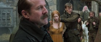 Movie still from “Hansel & Gretel: Witch Hunters” (2013), directed by Tommy Wirkola – A man with a mustache and a woman in a yellow dress; Close Up shot, Over the shoulder angle