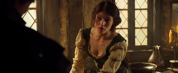 Movie still from “Hansel & Gretel: Witch Hunters” (2013), directed by Tommy Wirkola – A beautiful woman in a medieval dress looking into the camera; Close Up shot, Over the shoulder angle