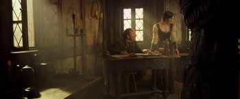 Movie still from “Hansel & Gretel: Witch Hunters” (2013), directed by Tommy Wirkola – A man sitting at a table in front of a woman; Medium shot, Low angle