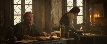 Movie still from “Hansel & Gretel: Witch Hunters” (2013), directed by Tommy Wirkola – A man sitting at a table in front of a woman; Medium shot, High angle