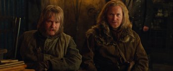 Movie still from “Hansel & Gretel: Witch Hunters” (2013), directed by Tommy Wirkola – Two men sitting next to each other in a room; Medium shot, Low angle