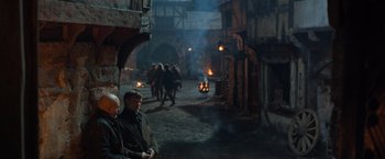 Movie still from “Hansel & Gretel: Witch Hunters” (2013), directed by Tommy Wirkola – A group of people walking down a street; Wide shot, High angle