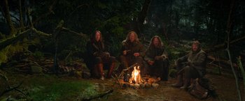 Movie still from “Hansel & Gretel: Witch Hunters” (2013), directed by Tommy Wirkola – A group of people sitting around a campfire; Wide shot, High angle