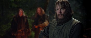 Movie still from “Hansel & Gretel: Witch Hunters” (2013), directed by Tommy Wirkola – A man with long hair and a goatee standing in front of another man with long hair; Medium shot, Over the shoulder angle