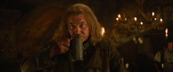 Movie still from “Hansel & Gretel: Witch Hunters” (2013), directed by Tommy Wirkola – A man with long hair is drinking from a mug; Close Up shot, Low angle