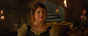 Movie still from “Hansel & Gretel: Witch Hunters” (2013), directed by Tommy Wirkola – A beautiful young lady wearing a green dress; Close Up shot, Over the shoulder angle