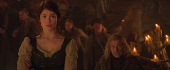 Movie still from “Hansel & Gretel: Witch Hunters” (2013), directed by Tommy Wirkola – A woman standing next to an older man in a cave; Medium shot, Over the shoulder angle