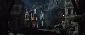 Movie still from “Hansel & Gretel: Witch Hunters” (2013), directed by Tommy Wirkola – A group of houses that are next to each other on a street; Extreme Wide shot, High angle