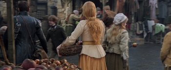 Movie still from “Hansel & Gretel: Witch Hunters” (2013), directed by Tommy Wirkola – A woman with long blonde hair holding a wicker basket; Medium shot, Over the shoulder angle