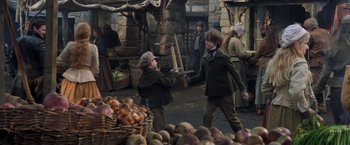 Movie still from “Hansel & Gretel: Witch Hunters” (2013), directed by Tommy Wirkola – Two boys are fighting in a market with onions; Medium shot, Over the shoulder angle