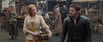 Movie still from “Hansel & Gretel: Witch Hunters” (2013), directed by Tommy Wirkola – A woman holding a basket in front of a crowd; Medium shot, Over the shoulder angle