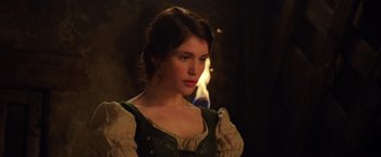 Movie still from “Hansel & Gretel: Witch Hunters” (2013), directed by Tommy Wirkola – A beautiful young lady wearing a green and white dress; Close Up shot, Over the shoulder angle