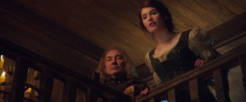 Movie still from “Hansel & Gretel: Witch Hunters” (2013), directed by Tommy Wirkola – A man and a woman standing next to a railing; Medium shot, Low angle