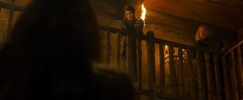Movie still from “Hansel & Gretel: Witch Hunters” (2013), directed by Tommy Wirkola – A woman is holding a rifle and looking at the camera; Medium shot, Over the shoulder angle