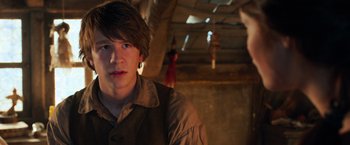 Movie still from “Hansel & Gretel: Witch Hunters” (2013), directed by Tommy Wirkola – A young man wearing a brown shirt in a room with wooden walls; Close Up shot, Over the shoulder angle
