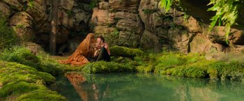 Movie still from “Hansel & Gretel: Witch Hunters” (2013), directed by Tommy Wirkola – A man and a woman sitting on the shore of a body of water; Wide shot, High angle