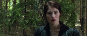 Movie still from “Hansel & Gretel: Witch Hunters” (2013), directed by Tommy Wirkola – A person wearing a jacket near a tree; Close Up shot, Over the shoulder angle