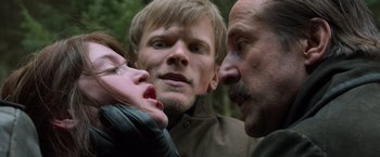 Movie still from “Hansel & Gretel: Witch Hunters” (2013), directed by Tommy Wirkola – Two men and a woman in the woods; Close Up shot, Over the shoulder angle