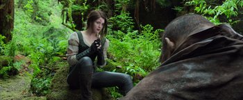 Movie still from “Hansel & Gretel: Witch Hunters” (2013), directed by Tommy Wirkola – A woman holding a knife in a forest; Medium shot, Over the shoulder angle