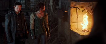 Movie still from “Hansel & Gretel: Witch Hunters” (2013), directed by Tommy Wirkola – A woman standing in front of an open door; Medium shot, Low angle