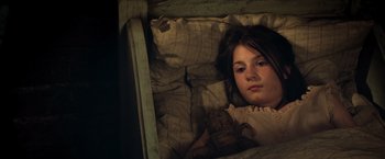 Movie still from “Hansel & Gretel: Witch Hunters” (2013), directed by Tommy Wirkola – A young girl laying in a bed with a teddy bear; Close Up shot, High angle