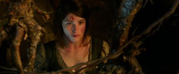 Movie still from “Hansel & Gretel: Witch Hunters” (2013), directed by Tommy Wirkola – A woman with a scar on her face looking at the camera; Close Up shot, High angle