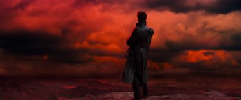 Movie still from “Hansel & Gretel: Witch Hunters” (2013), directed by Tommy Wirkola – A man standing in front of a red sky; Wide shot, Low angle