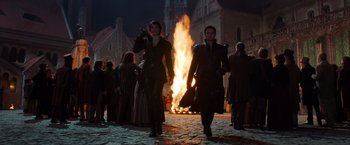 Movie still from “Hansel & Gretel: Witch Hunters” (2013), directed by Tommy Wirkola – A couple of people that are walking in front of a fire; Wide shot, Low angle
