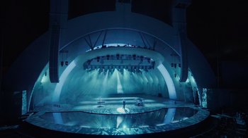 Movie still from “Happier Than Ever: A Love Letter to Los Angeles” (2021), directed by Patrick Osborne – A stage that has a lot of lights on it; Extreme Wide shot, High angle