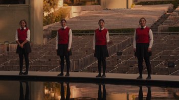 Movie still from “Happier Than Ever: A Love Letter to Los Angeles” (2021), directed by Patrick Osborne – A group of young women standing next to each other in front of an outdoor stage; Wide shot, High angle