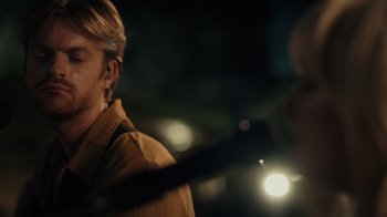 Movie still from “Happier Than Ever: A Love Letter to Los Angeles” (2021), directed by Patrick Osborne – A man holding a flashlight in his hand; Close Up shot, Over the shoulder angle