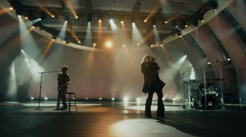 Movie still from “Happier Than Ever: A Love Letter to Los Angeles” (2021), directed by Patrick Osborne – Two people are standing in the middle of an empty stage; Wide shot, Low angle