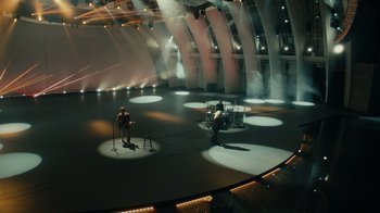 Movie still from “Happier Than Ever: A Love Letter to Los Angeles” (2021), directed by Patrick Osborne – Two men are standing in the middle of an empty stage; Extreme Wide shot, High angle