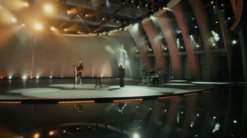 Movie still from “Happier Than Ever: A Love Letter to Los Angeles” (2021), directed by Patrick Osborne – A group of people standing in an empty room; Extreme Wide shot, High angle