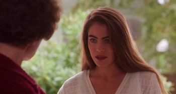 Movie still from “Hard Target” (1993), directed by John Woo – A young woman with long brown hair talking to a man; Close Up shot, Over the shoulder angle