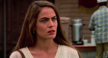 Movie still from “Hard Target” (1993), directed by John Woo – A person with long brown hair; Close Up shot, Over the shoulder angle