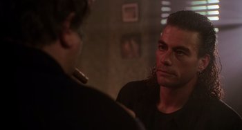 Movie still from “Hard Target” (1993), directed by John Woo – A man looking at himself in the mirror; Close Up shot, Over the shoulder angle