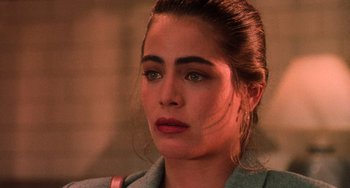 Movie still from “Hard Target” (1993), directed by John Woo – A woman's face with a purse; Close Up shot, Over the shoulder angle