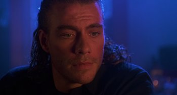 Movie still from “Hard Target” (1993), directed by John Woo – A person wearing a black shirt; Close Up shot, Low angle
