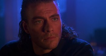 Movie still from “Hard Target” (1993), directed by John Woo – A person wearing a black shirt; Close Up shot, Low angle