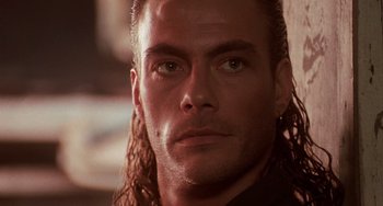 Movie still from “Hard Target” (1993), directed by John Woo – A person with long hair; Close Up shot, Low angle