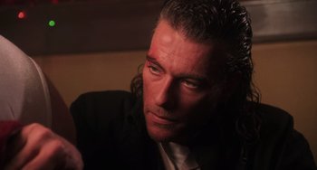 Movie still from “Hard Target” (1993), directed by John Woo – A person with long hair; Close Up shot, Low angle