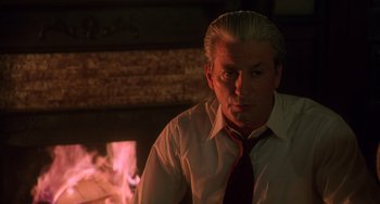 Movie still from “Hard Target” (1993), directed by John Woo – A man in a white shirt and a red neck tie; Close Up shot, Low angle