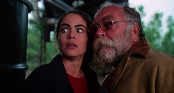 Movie still from “Hard Target” (1993), directed by John Woo – An older man and a younger woman looking at the camera; Close Up shot, Low angle