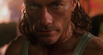 Movie still from “Hard Target” (1993), directed by John Woo – A person with wet hair; Close Up shot, Low angle